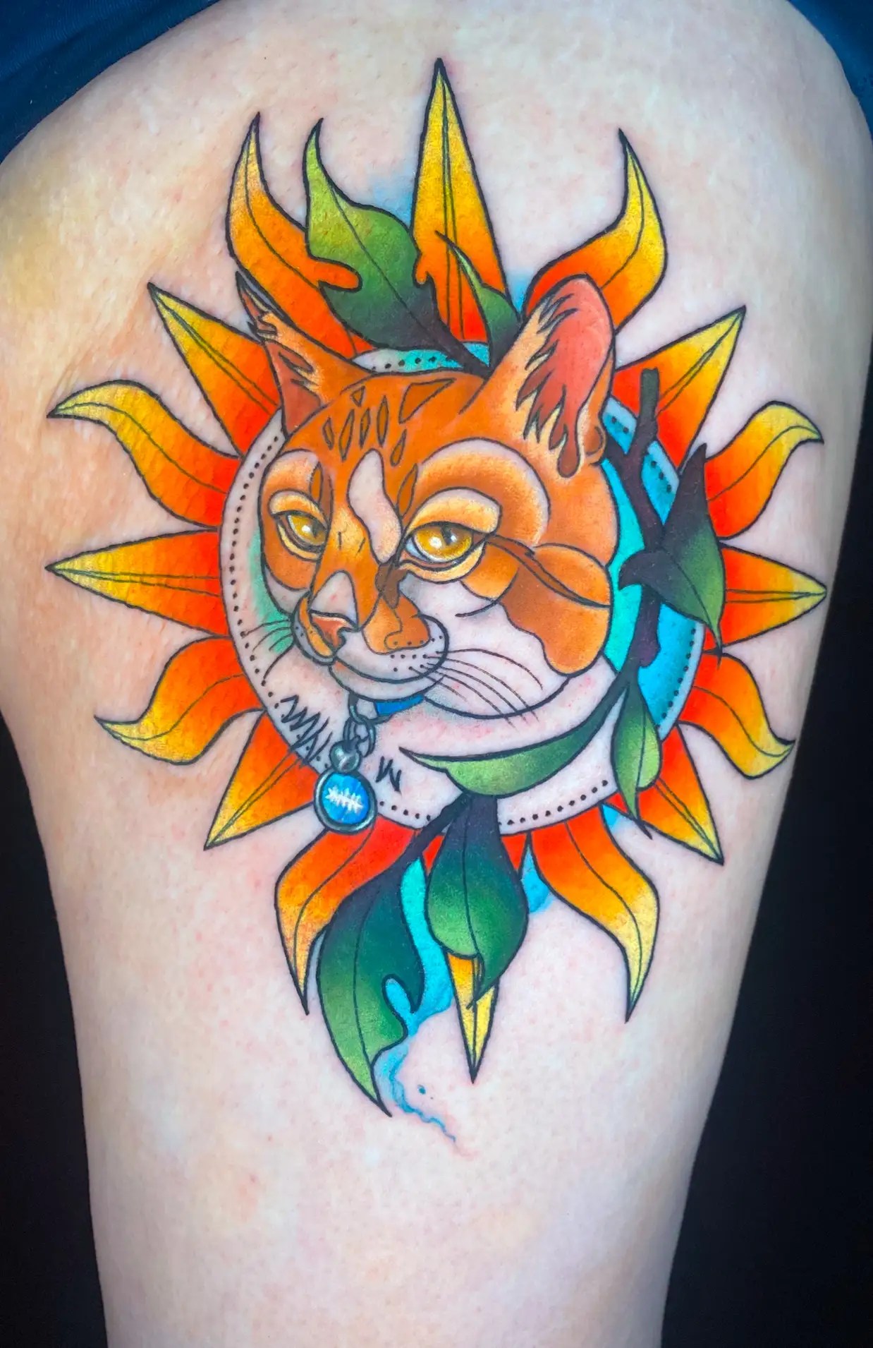 Tattoo of a cat portrait in a sun