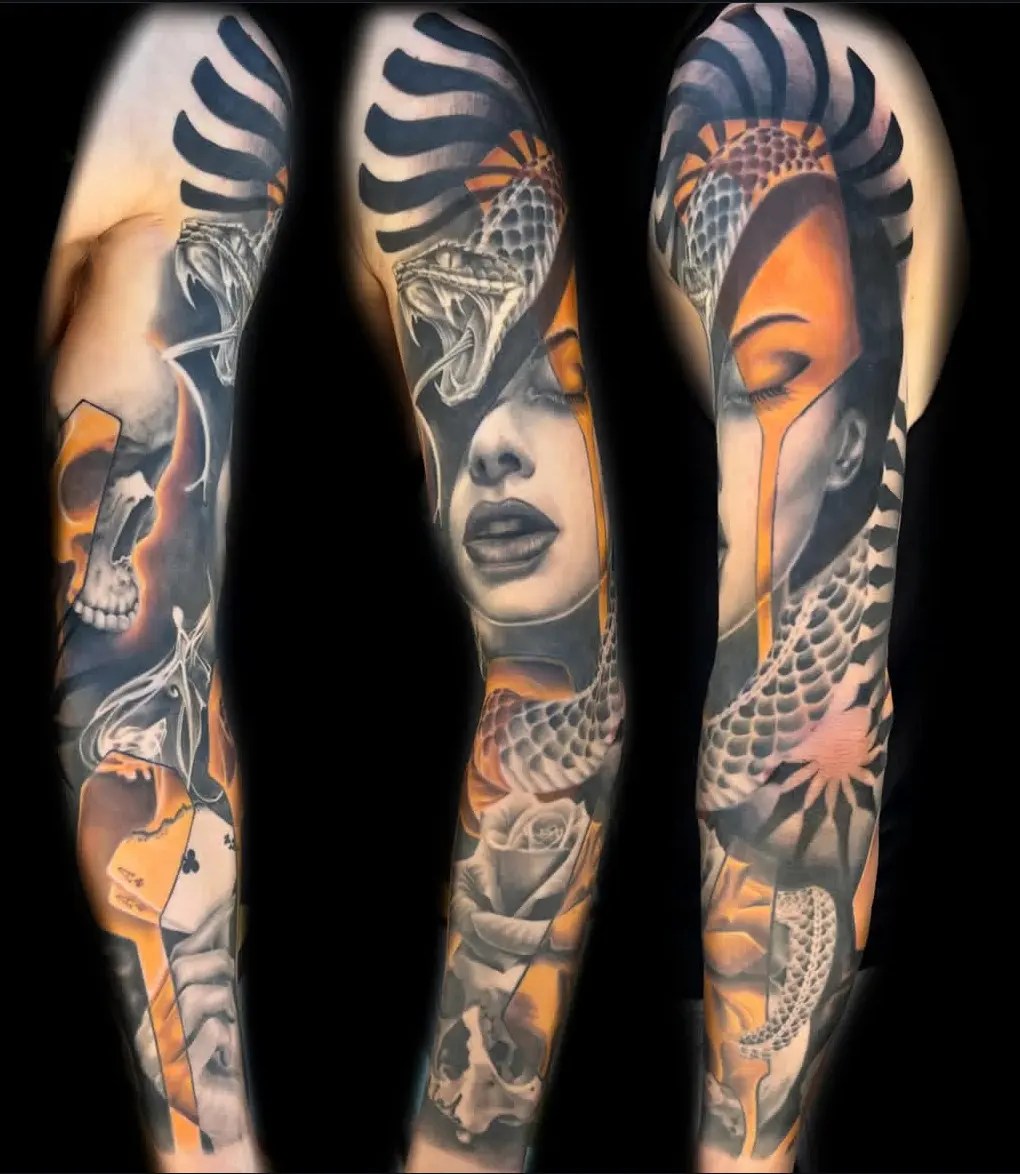 Abstract black, grey and gold tattoo of a woman, skulls, snake, and a flower
