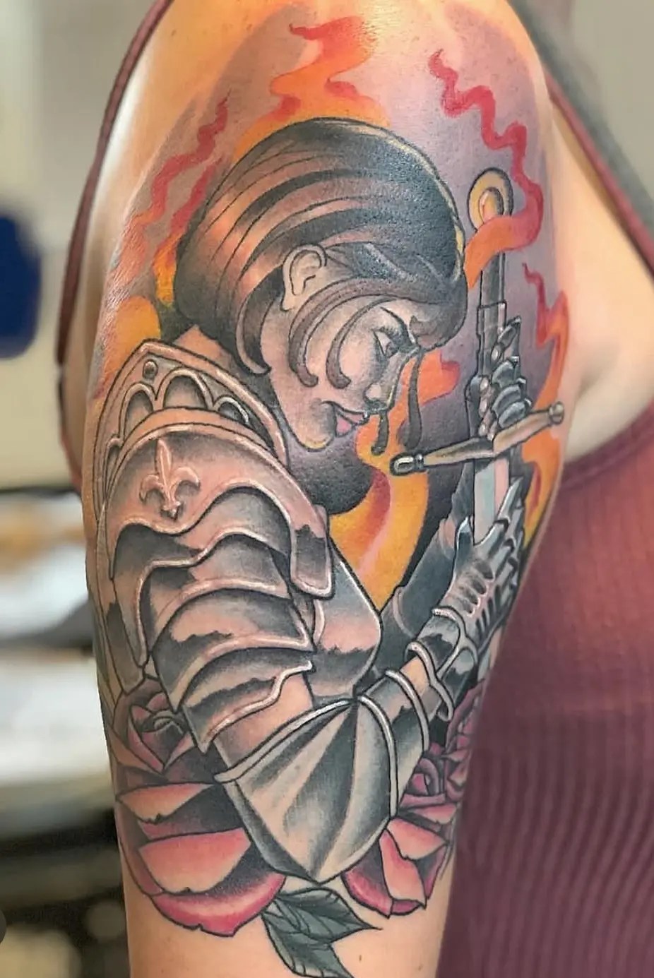Tattoo of a women in armor with a sword and flowers
