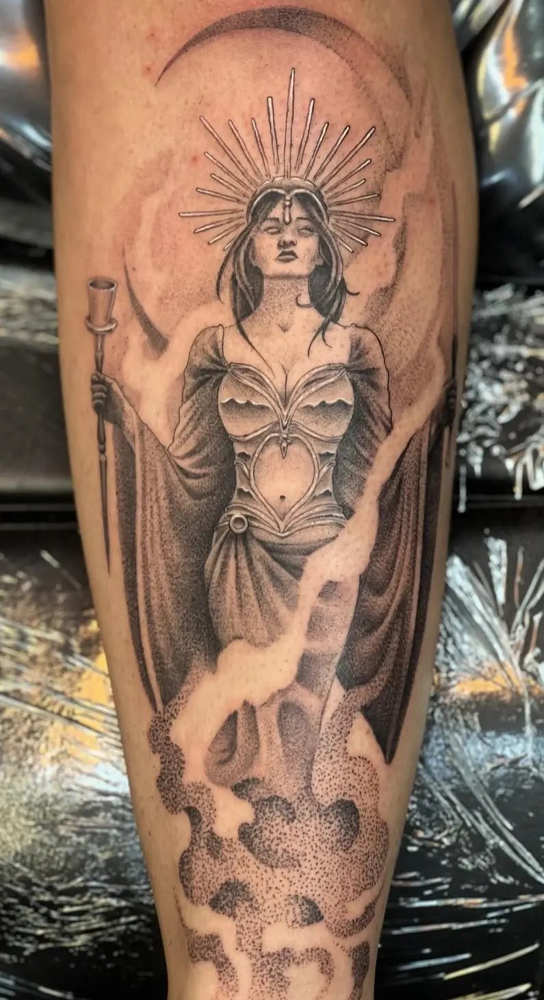Black and grey tattoo of a woman in front of a crescent moon