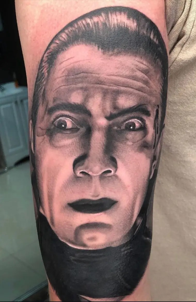 Black and grey portrait tattoo of a man