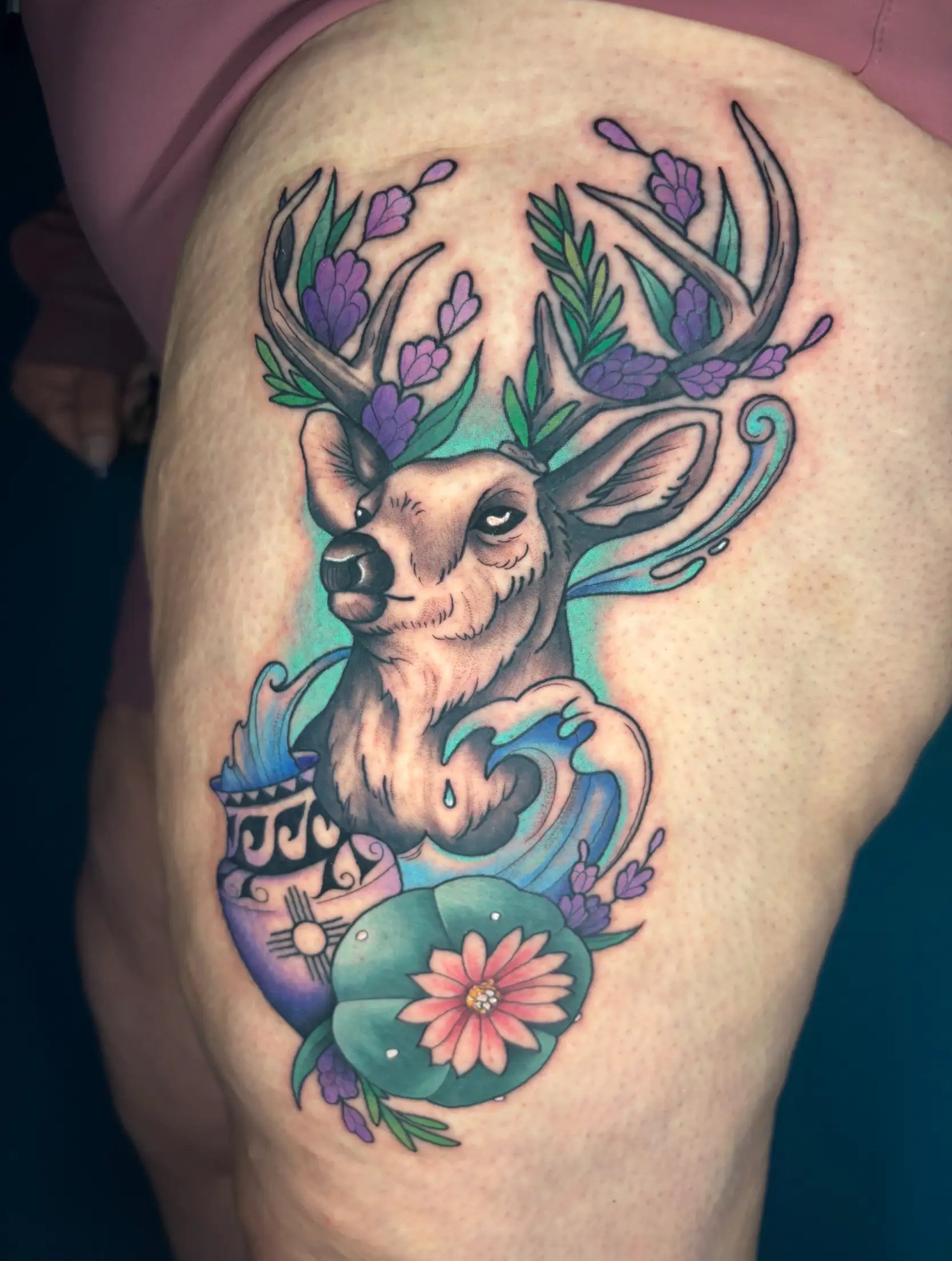 Tattoo of an elk with flowers and New Mexico pottery