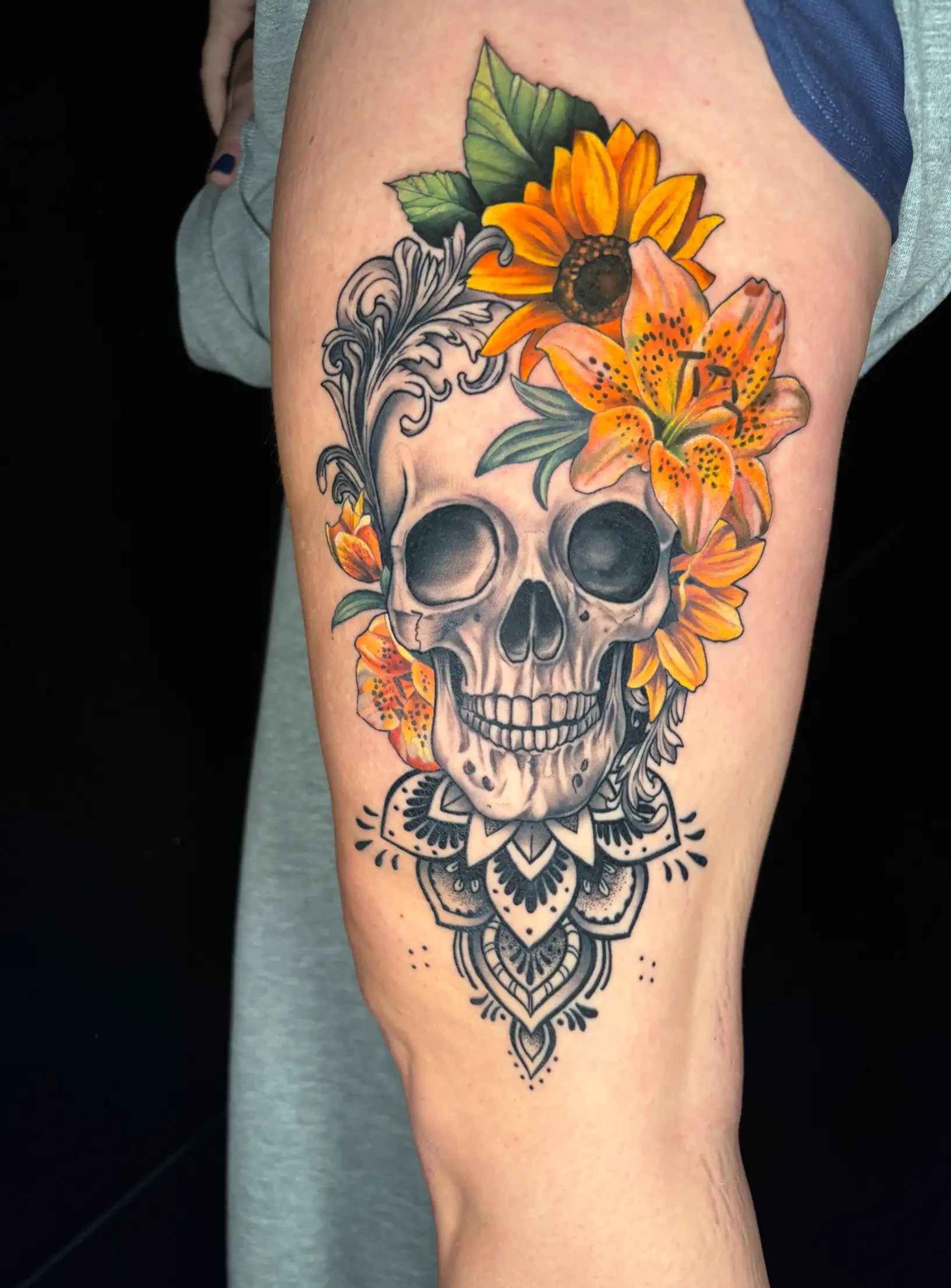 Black and grey skull and mandala tattoo design mixed with colorful flowers