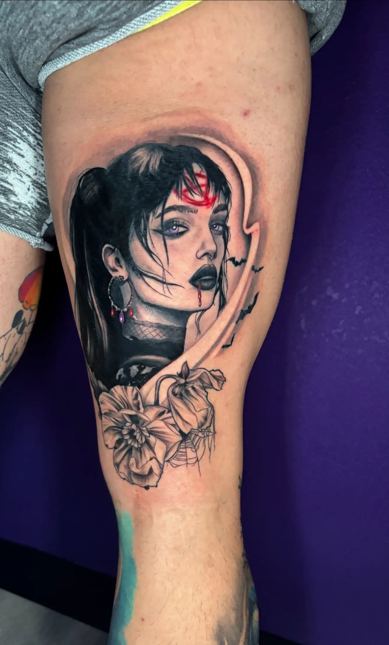 Black and grey realistic portrait tattoo with flowers