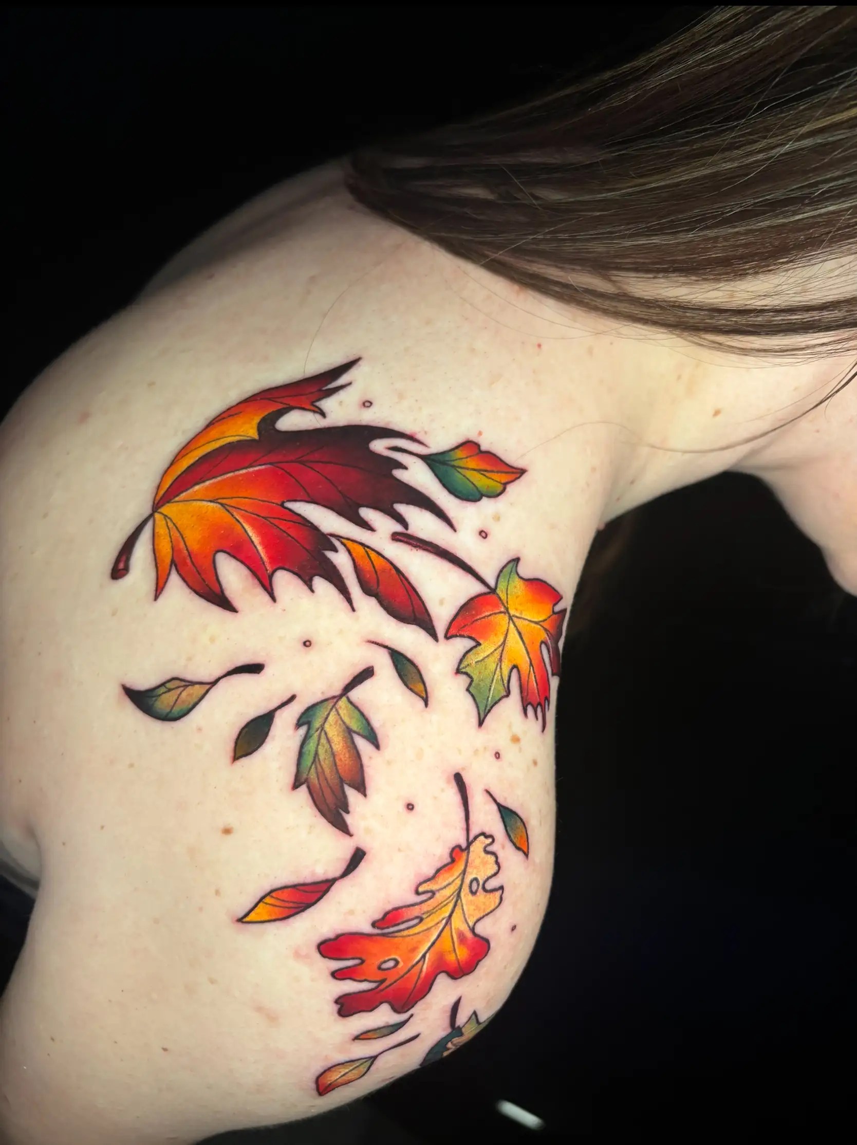 Tattoo of fall leaves in the wind