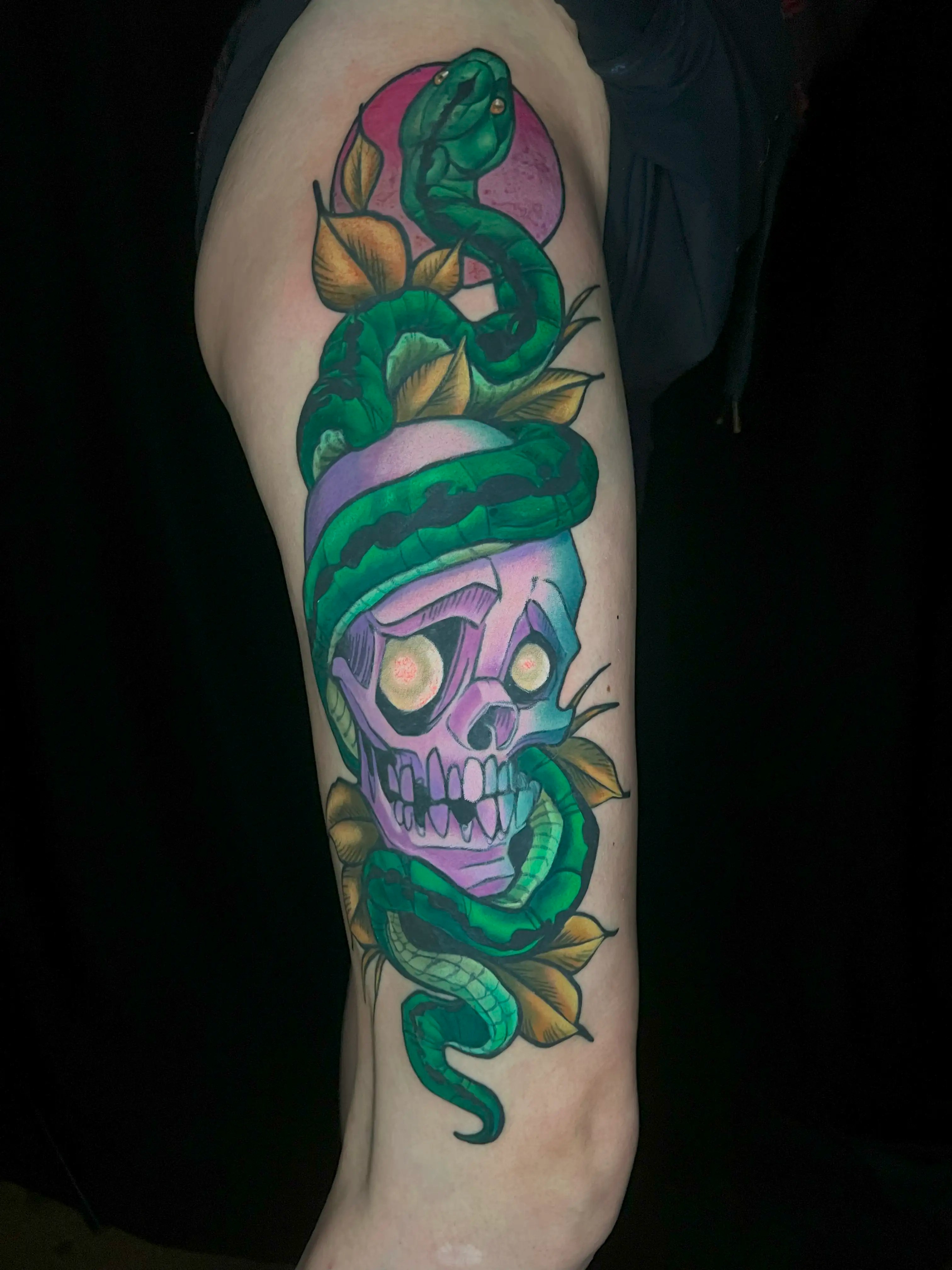 New school tattoo of a snake and skull